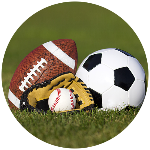 football soccer ball and baseball glove on grass