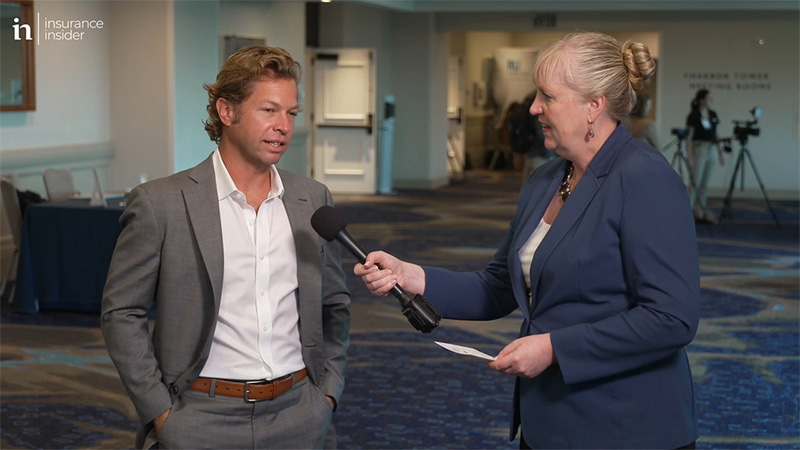 Woman interviewing man at conference