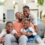 Smiling family sitting on couch